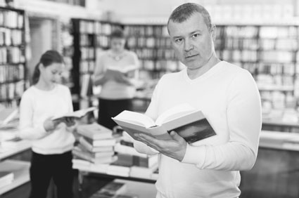 Man finding a book in a bookstore